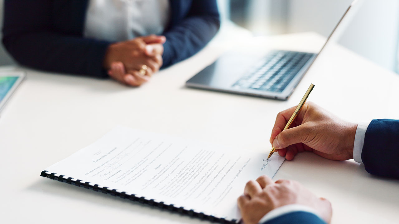 Two people discussing documents
